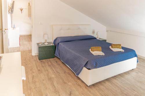 a bedroom with a bed with two towels on it at La Vela dei Sogni in Misano Adriatico