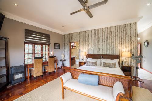a bedroom with a bed and a living room at Tuareg Guest House in Midrand