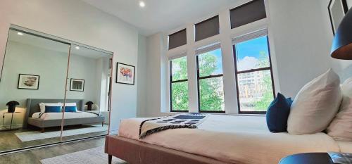 a bedroom with a bed and a large window at The Lofts on Clematis 202 Downtown West Palm Beach in West Palm Beach