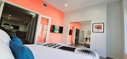 a bedroom with orange walls and a bed in a room at The Lofts on Clematis 202 Downtown West Palm Beach in West Palm Beach