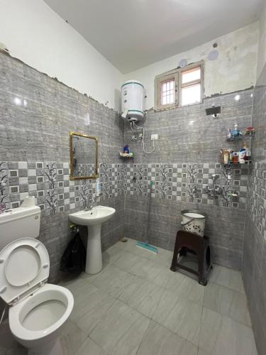 a bathroom with a toilet and a sink at A Place To Call Home in Jammu