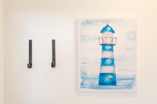 a painting of a blue and white lighthouse at STAR of the SEA in Jesenice