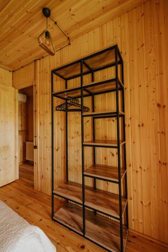 a book shelf in a room with wooden walls at Seaside Cottages in Batumi