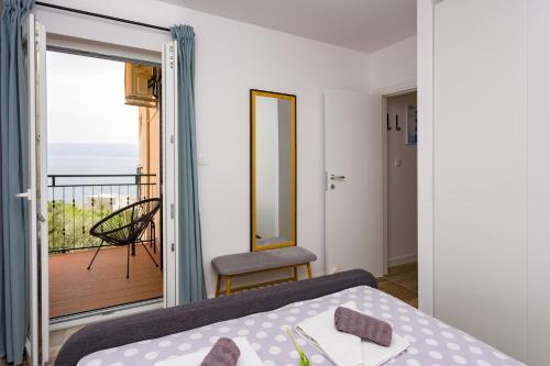 ein Schlafzimmer mit einem Bett und einem Balkon in der Unterkunft STAR of the SEA in Jesenice