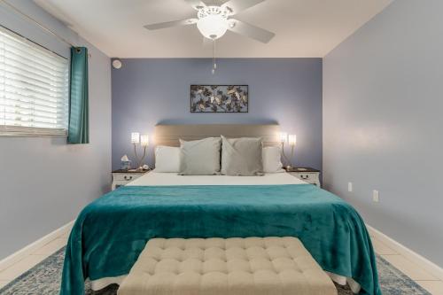 a bedroom with a large bed with a green blanket at Tranquility Seahorse Suite - Oceanfront Paradise! in Melbourne Beach