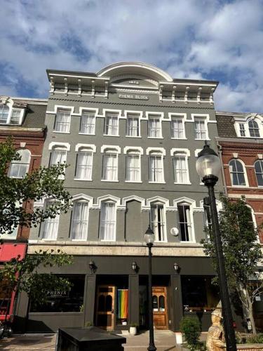 a large gray building on a city street with a street light at West Market Square View, Historic Hotel DTWN, King Bed, Room # 401 in Bangor