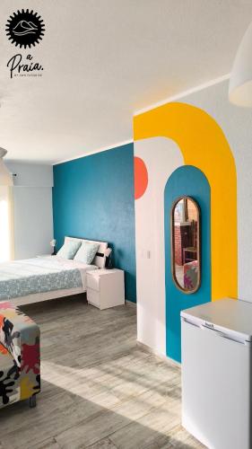 a bedroom with a bed and a mirror on the wall at A Praia, My Own Paradise- Estúdio in Figueira da Foz