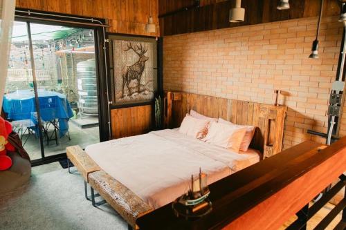 a bed in a room with a brick wall at New York Loft & Japanese Magic by V4SKIN in Bangkok