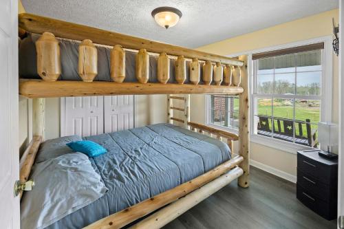a bedroom with a bunk bed and a window at Private Farmhouse with Hot Tub in Dandridge
