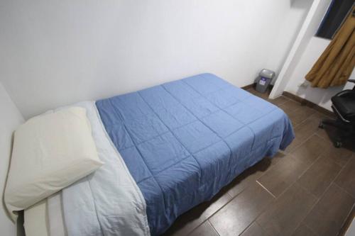 a bedroom with a bed with a blue blanket on it at House for 3 people in Urubamba in Urubamba