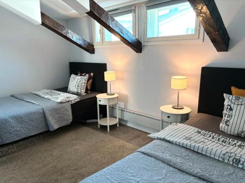 a bedroom with a bed and two lamps in it at Hamina Bastion Apartments in Hamina