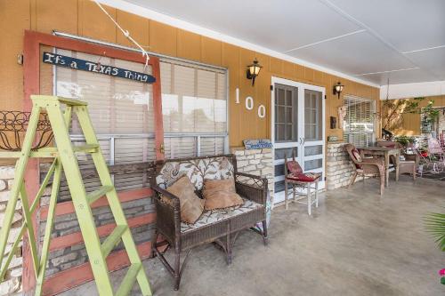 a room with a building with a table and chairs at Binky's Summer Afternoon in Fredericksburg