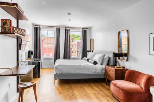a living room with a bed and a couch at Market Square View, Heart of DTWN, Historic Hotel, King Bed, Room # 402 in Bangor