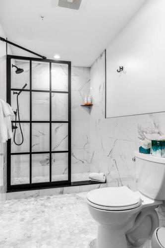 a white bathroom with a toilet and a shower at Market Square View, Heart of DTWN, Historic Hotel, King Bed, Room # 402 in Bangor