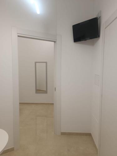 a white room with a television on a wall at Villa Matilde Monteroni in Monteroni di Lecce