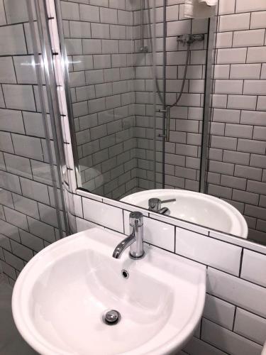 a bathroom with a white sink and a mirror at Nysdill Accommodation Ltd in Norwich