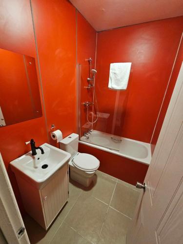 a bathroom with a toilet and a sink and a shower at Nysdill Accommodation Ltd in Norwich