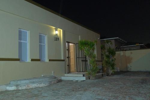 a building with a door and some plants in front of it at SUPA Lodge in Parow