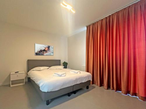 a bedroom with a bed and a red curtain at ALL SEASONS in Feleacu