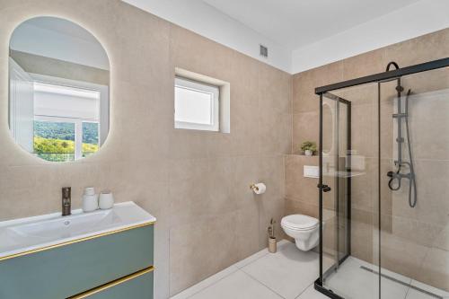 a bathroom with a shower and a toilet and a sink at NEW Villa Carmen with 5 en-suite bedrooms, 48 sqm pool, 8km from sea in Tugare