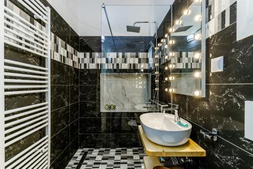 a bathroom with a sink and a mirror at House Victoria in Skopelos Town