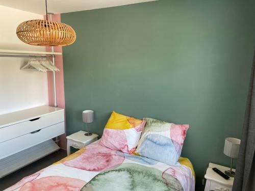 a bedroom with a bed with colorful pillows at T2 soleil et mer in Bandol