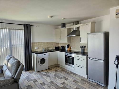 a kitchen with a refrigerator and a washing machine at Skyview retreat in Derry Londonderry