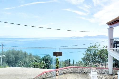 a view of the ocean from a balcony of a house at Andromachi Escape! in Katávolos