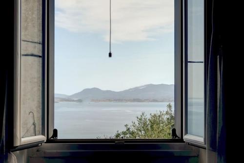 an open window with a view of the ocean at Andromachi Escape! in Katávolos