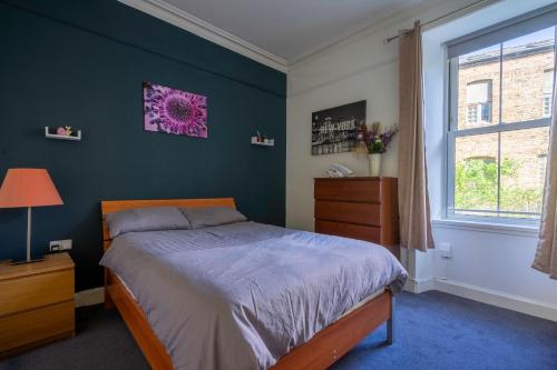 a bedroom with a bed and a window at The Eden Apartment, Edinburgh City Center in Edinburgh