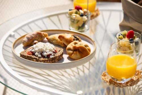a glass table with a plate of food on it at Reveli Suites in Katelios