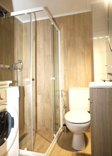 a bathroom with a toilet and a glass shower at xanthi BnB1 in Xanthi