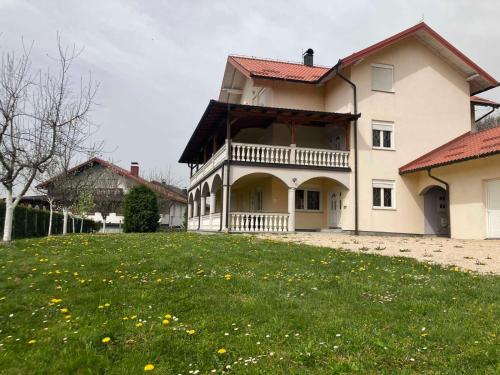 a large house with a large yard in front of it at Family Apartment Miki in Teslic in Teslić