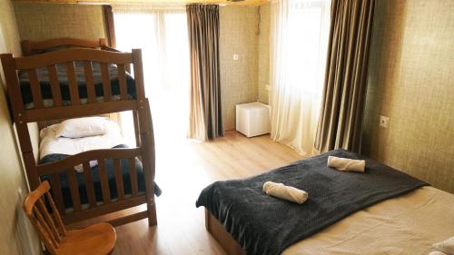 a bedroom with two bunk beds in a room at Archil and Nino Gigauri Guest House in Stepantsminda