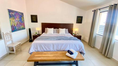 a bedroom with a large bed with a wooden headboard at San Angel Villas in San Antonio