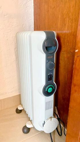 a white radiator with a remote control next to a wall at San Angel Villas in San Antonio
