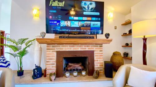 a living room with a fireplace with a flat screen tv at San Angel Villas in San Antonio