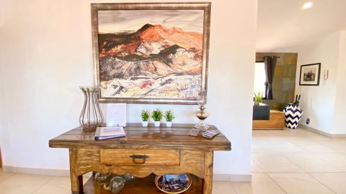 a table in a room with a painting on the wall at San Angel Villas in San Antonio