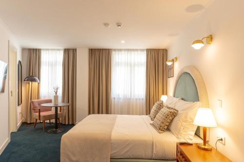 una habitación de hotel con una cama y una mesa en Westlight Lisboa Madalena, en Lisboa