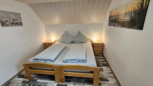 a small bed in a room with two lights at AMW Ferienwohnungen in Legau