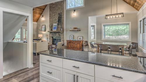 a kitchen with a table and a dining room at Lake Cove Oasis in Morganton