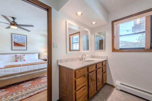 a bathroom with a sink and a bed at Grand Angel Fire mountain luxury ski chalet in Angel Fire