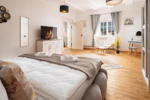 1 dormitorio con 1 cama grande y chimenea en Luxus wohnen im Schloss Corvey für 1-6 Gäste im UNESCO Weltkulturerbe Höxter Weserbergland free W-Lan Parken Netflix für Familien Paare und Geschäftsreisende inkl Handtücher Seife Nintendo Switch uvm, en Höxter