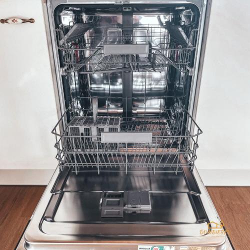 an open dishwasher with its dishes inside of it at Ďumbierky Chata 6ka in Mýto pod Ďumbierom