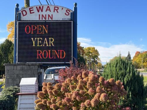 a sign for an open year round sign at Dewar's Inn and Cottages in Prescott