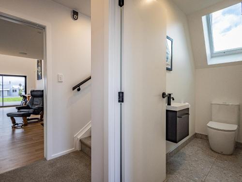 a bathroom with a toilet and a window at Findlay Chalet - National Park Holiday Home in National Park