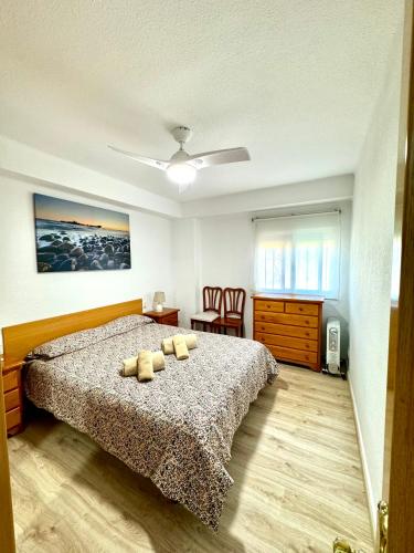 a bedroom with a bed with two pillows on it at Apartamento Ciudamar in Puerto de Sagunto
