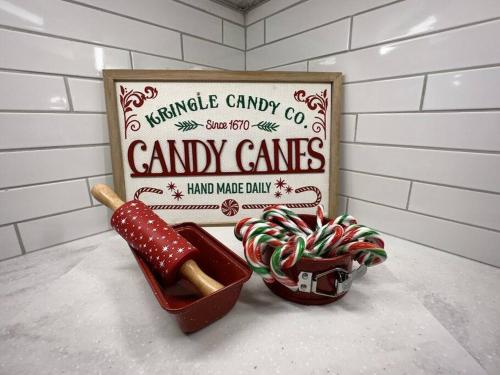 a sign with candy canes and a box of candy canes at Tranquil ski golf spa in Collingwood