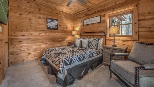 a bedroom with a bed and a couch in a cabin at Lake Escape in Morganton