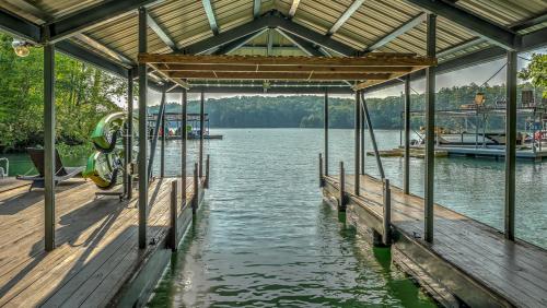 a dock on a lake with a boat in the water at Lake Escape in Morganton